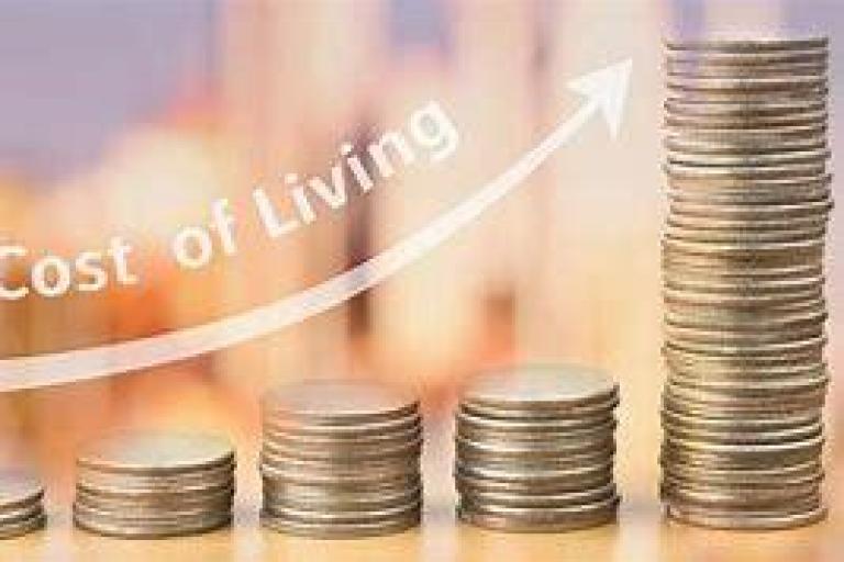 Image of coins with the text Cost of Living 