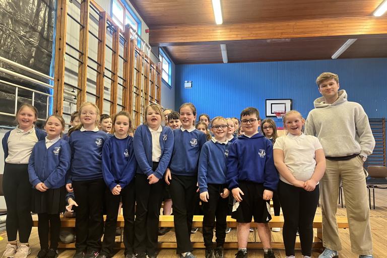 Pupils lined up for a photo next to Morgan 