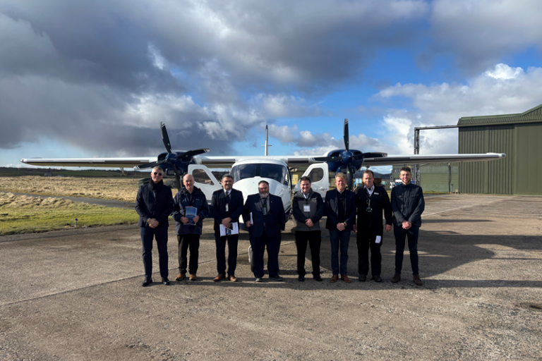 Representatives from Comhairle nan EIlean Siar and Hebridean Air Services in front of a plane