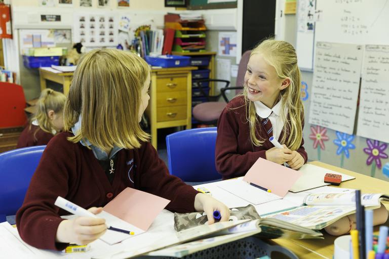 Two school pupils at their desk 